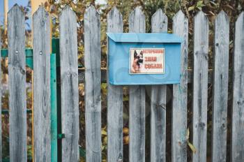 Fence with a mail box on it.