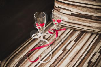 Striped chair with decorated red glasses.