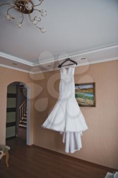 Wedding dress on a hanger.