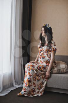 The girl during pregnancy in a beautiful dress.