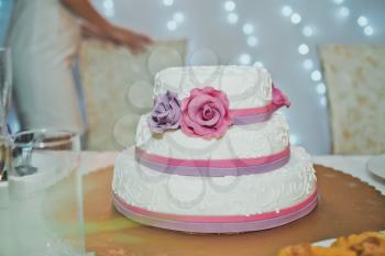 Big wedding cake with roses.