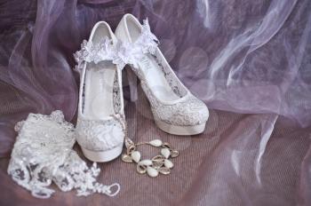 Shoes, garter and necklace for the bride.