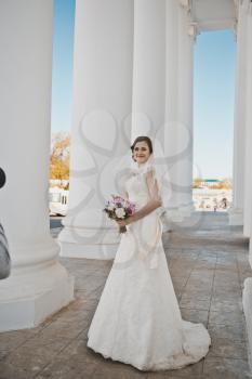 Bride in white columns.