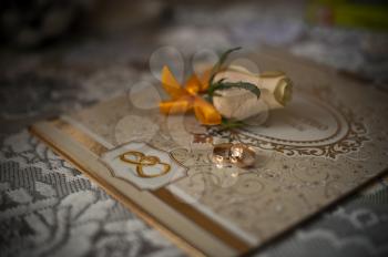 Wedding rings and buttonhole on a card.