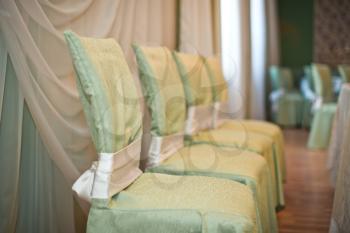 Decorated with a gentle and green and pink fabric chairs in a festive hall.