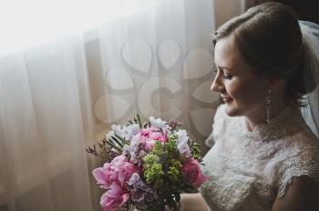 Portrait of a girl with bouquet in hand.