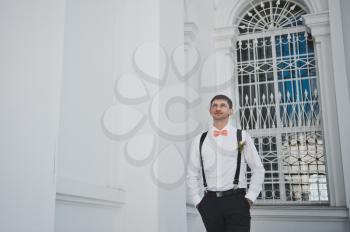 The groom at the white window.