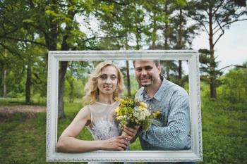 Portrait in a frame against wood.