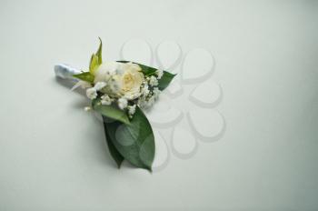 Beautiful buttonhole from a rose and white florets.