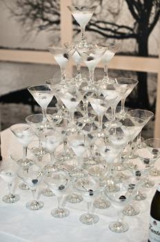 Pyramid from glasses for wine and champagne with pistachios.