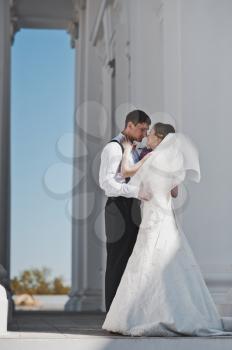 Husband and wife hugging on the background of the Church.