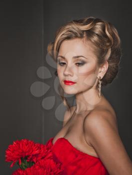 Portrait of the beautiful girl in a red dress.