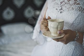 The bride is drinking coffee in the morning.