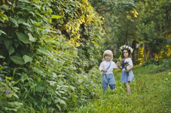 The children walk along the summer garden.