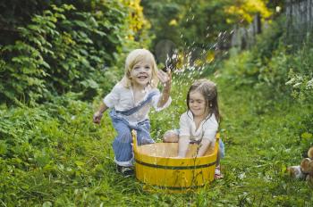 Children play with water in the garden.