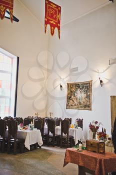 A long festive table with several chairs for guests.