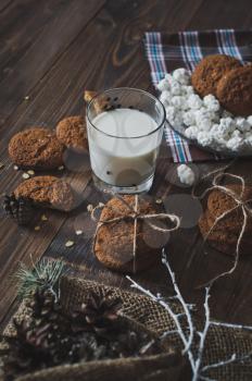 A glass of milk with cookies.