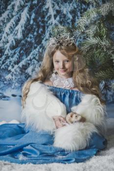 Snow Princess is sitting in the snow around Christmas trees.