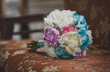 Colorful wedding bouquet on vintage chair.