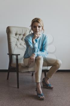 Girl on a beige chair.
