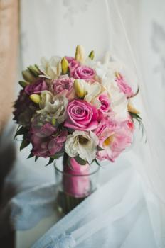 Bouquet from roses and other flowers on a table.