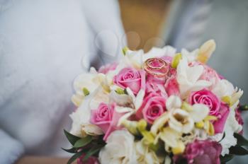 Bouquet of beautiful flowers in hands of the bride.