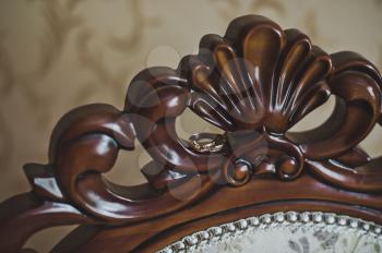 The decorative elements of the chair back carved out of wood.