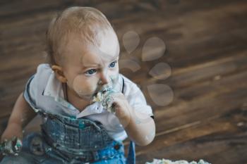 Portrait of a baby smeared with cake.