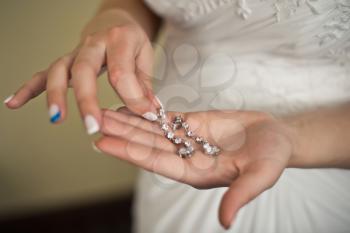 The young woman holds ornaments which is going to put on wedding.