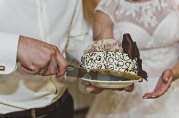The couple cut the cake into pieces.