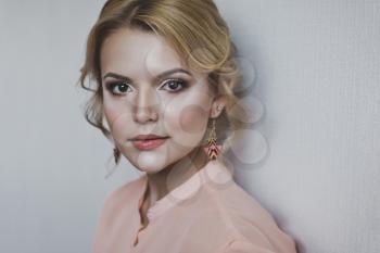 The girl with the makeup and hairdo on the portrait.