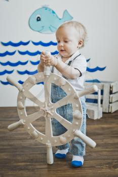 One-year-old child holds the wheel.