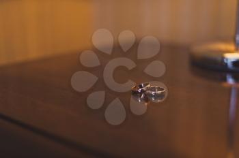 Two rings on a wooden table.
