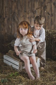 Portrait of children playing in the barn.