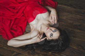 The girl in the red dress lying on the floor.