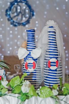 Bottle in costumes on the marine theme.