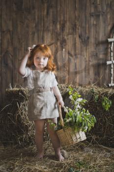 The girl with red hair with a basket.