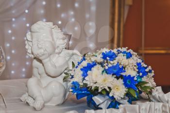 Angel statue next to the bouquet.