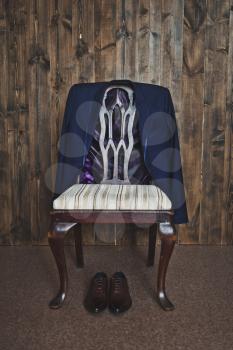 The chair laid on his suit and shoes.