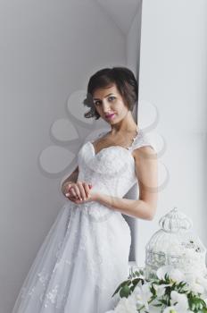 Portrait of a beautiful girl in a wedding dress in the Studio.