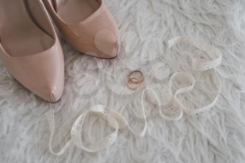 Beige shoes and rings.