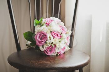 A bouquet of flowers lying on the stool.