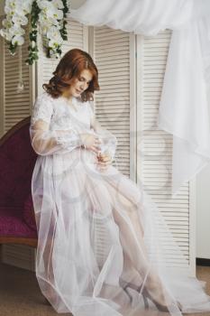 Promotional Studio shot of a pregnant woman.