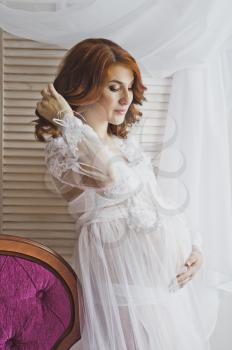 Redhead pregnant girl in a delicate situation.