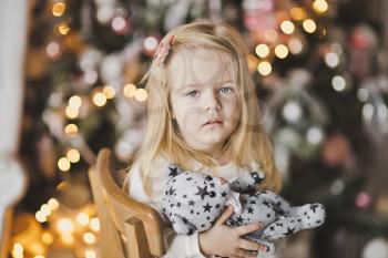 Portrait of a child on the Christmas lights.