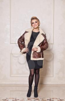Model in a stylish sheepskin coat.