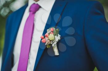 Miniature bouquet on the lapel of the groom.