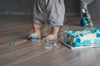 A child plays with a sweet cake.