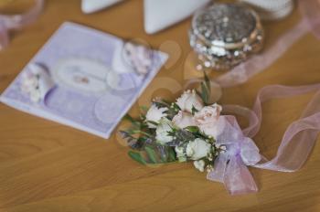 Beautiful elements of the wedding outfit of the bride on the table.