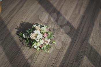 Original wedding bouquet of miniature roses and greenery.
